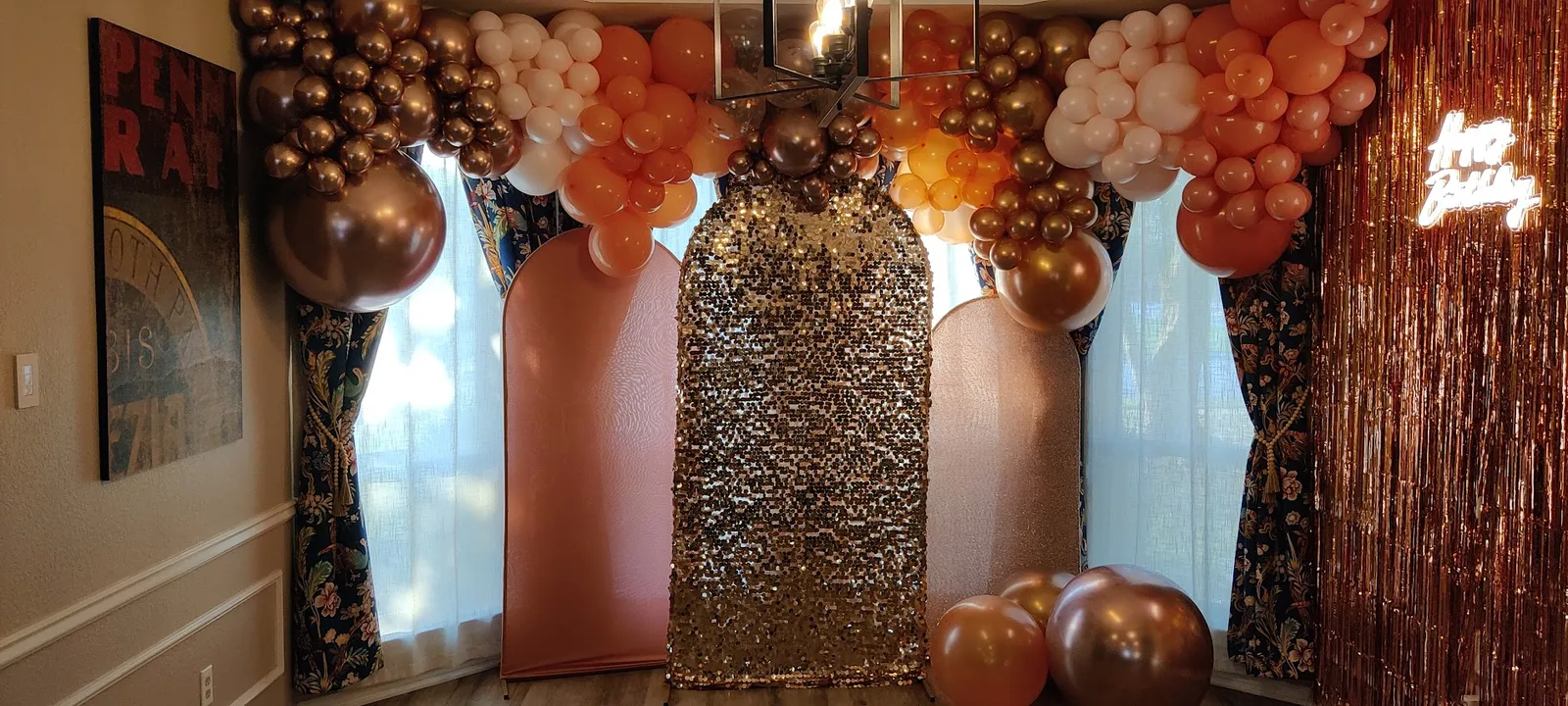 An organic balloon garland in rose-gold chrome, copper, peach, and cream draped over three arched backdrop panels and a gold sequin shimmer wall, with a rose-gold foil fringe curtain and a neon sign, built for a Sweet 16 pool party in Northlake Woodlands, Coppell, TX.